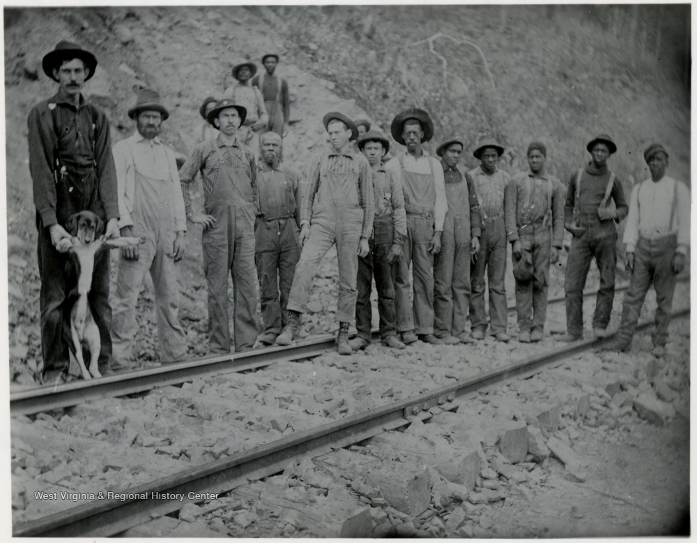 A racially diverse crew of railroad workers poses along the tracks in a West Virginia mountain cut, early 20th century. West Virginia Regional History Center.